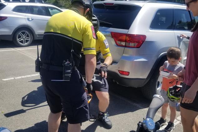 LT Ray and Paramedic Wynslow assisting with a youngster's bike